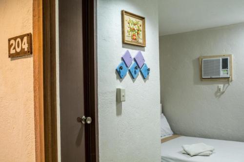 a room with a bed and a door to a room at Hotel Avenija in Olongapo