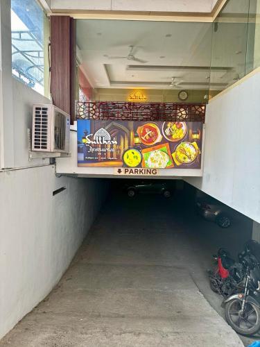 a fast food restaurant with a sign in a tunnel at Sulthan Hotel & Restaurant in Cochin