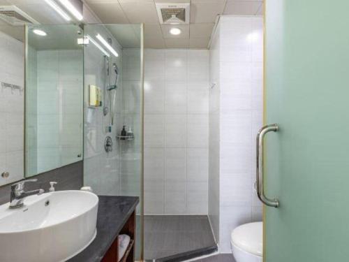 a bathroom with a sink and a toilet at City Comfort Inn Xiangyang Railway Station in Xiangyang