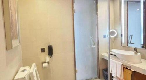 a bathroom with a sink and a toilet and a shower at Lavande Hotel·Dongxing Port in Fangcheng