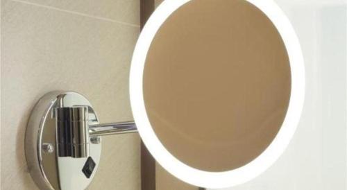 a bathroom with a mirror on the wall at Lavande Hotel·Dongxing Port in Fangcheng