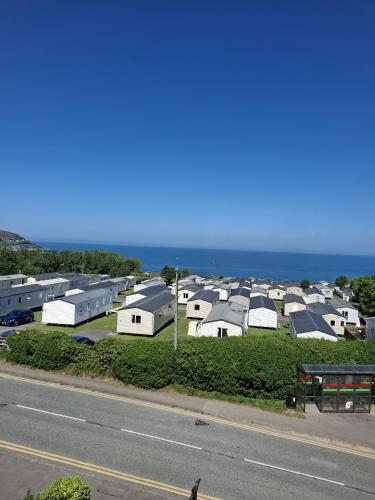 a row of houses with the ocean in the background at The Cambrian in New Quay