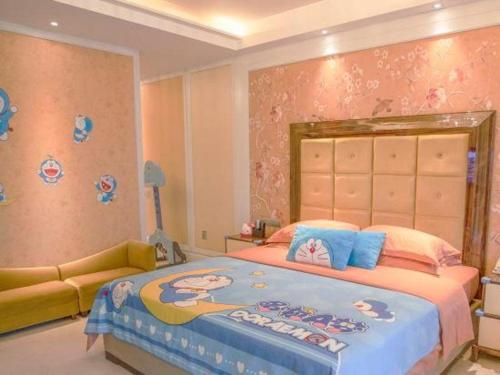 a bedroom with a large bed and a couch at Fortune International Hotel in Xiawutun