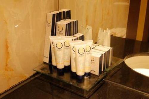 a group of toiletries on a counter in a bathroom at G'Sign Hotel Banjarmasin in Sungai Lutus