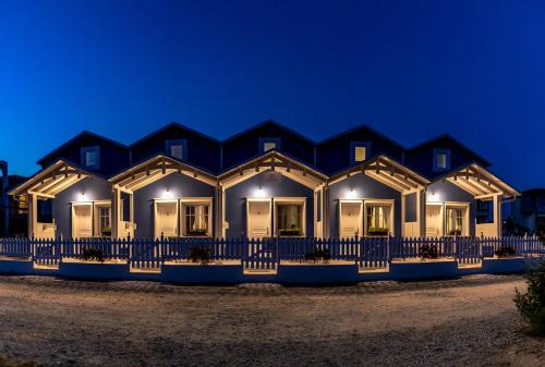 a row of homes at night with lights at Nafsika Suites in Nea Moudania