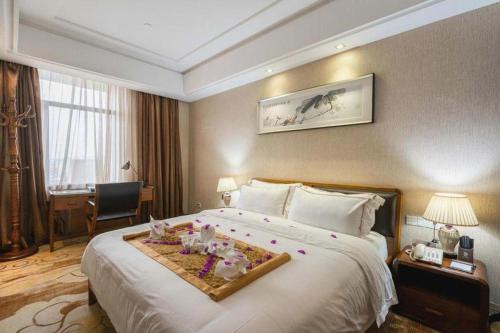 a hotel room with a large bed with decorations on it at Boya Holiday Hotel in Guangzhou