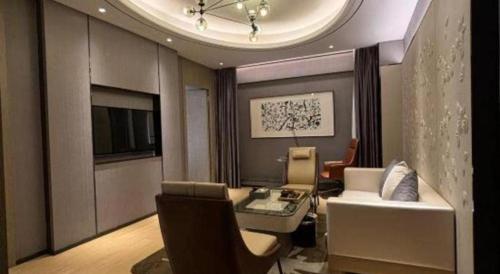 a living room with a couch and a table at Clear Lake Hotel in Shanwei
