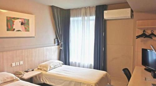 a hospital room with a bed and a television at Jinjiang Inn Wuhu Fangte Tech Museum Metro Station in Wuhu
