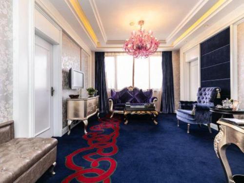 a living room with a large red snake carpet at Hohhot Inner Mongolia Hotel in Hohhot