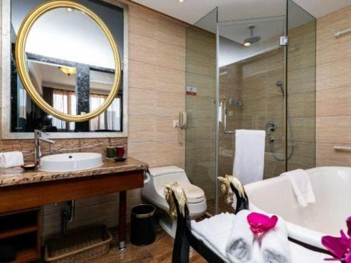 a bathroom with a tub and a toilet and a sink at Hohhot Inner Mongolia Hotel in Hohhot