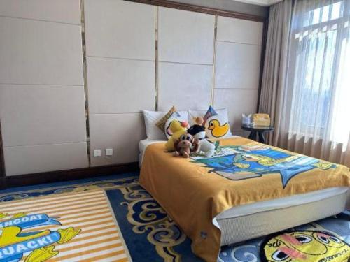 a bedroom with a bed with stuffed animals on it at Hohhot Inner Mongolia Hotel in Hohhot