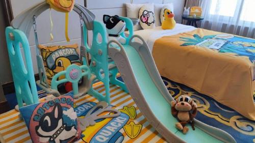 a childs bedroom with a bed and a play set at Hohhot Inner Mongolia Hotel in Hohhot