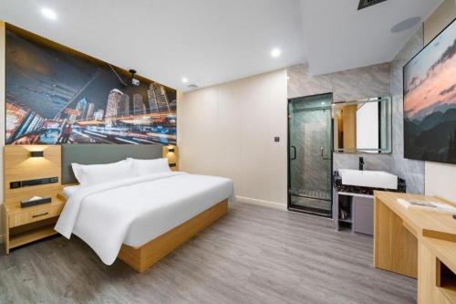 Cama o camas de una habitación en Sheng Lin Na Hotel Minzhi Branch