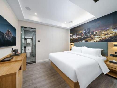 Cama o camas de una habitación en Sheng Lin Na Hotel Minzhi Branch