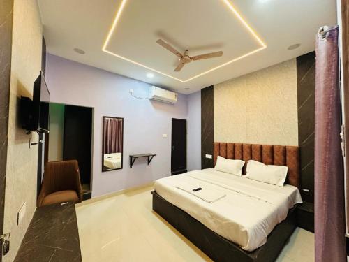a bedroom with a bed and a television in it at Hotel Airport Suites Suitable for Hourly Bookings in Lucknow
