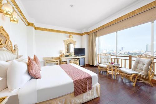 a hotel room with a bed and a balcony at Senriver Hotel in Da Nang