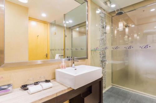 a bathroom with a sink and a shower at The Bauhinia in Shenzhen