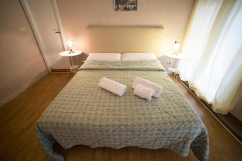 a bedroom with a bed with two pillows on it at Hotel Biscari in Catania