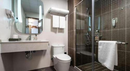 une salle de bain avec une douche, des toilettes et un lavabo dans l'établissement Ibis Lianyungang Guanyun County Downtown Hotel Hotel, à Guanyun