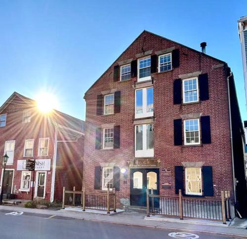 a brick building with the sun shining on it at Sweet two bedrooms building in downtown in Charlottetown