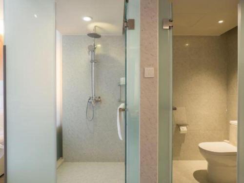 a bathroom with a shower and a toilet at Jinjiang Metropolo Shanghai Xujiahui Nanhuating Hotel in Shanghai