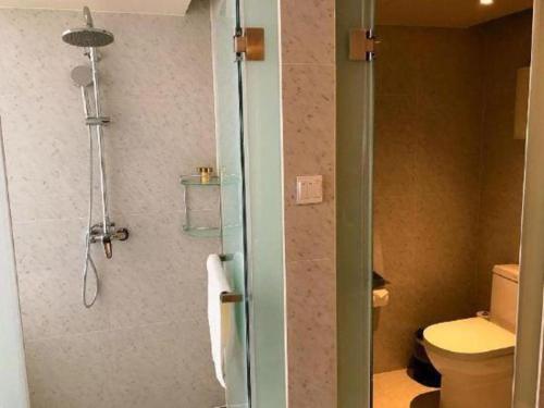 a bathroom with a shower and a toilet at Jinjiang Metropolo Shanghai Xujiahui Nanhuating Hotel in Shanghai