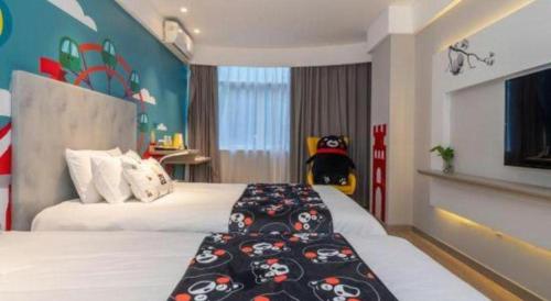 a hotel room with two beds and a stuffed animal at Magnotel Fuzhou Wuyi Road Sanfangqixiang in Fuzhou