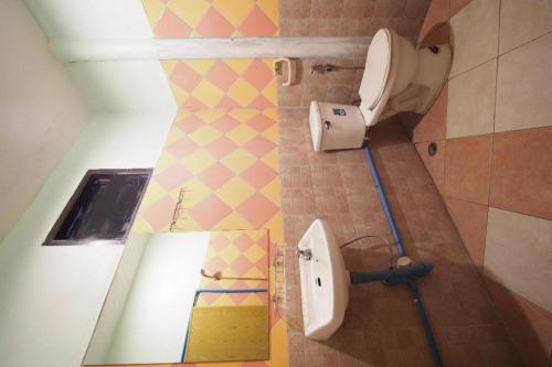a bathroom with a toilet and a sink at OYO 931 Sor Chareanpanit in Pattaya Central