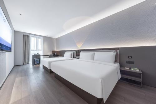 a hotel room with two white beds in it at Atour Light Hotel Beijing West Railway Station Liuliqiao Subway Station in Beijing