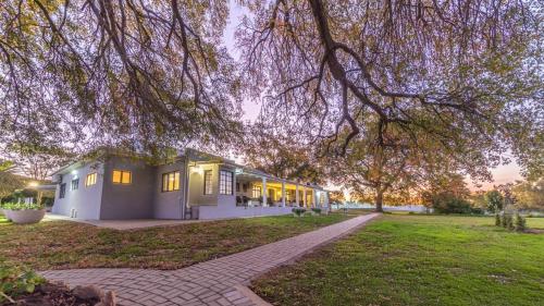 a house with lights on in a park at Room 4 - LEO Sky Guest House in Simondium