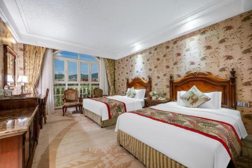 a hotel room with two beds and a window at Hangzhou The First World Hotel in Hangzhou