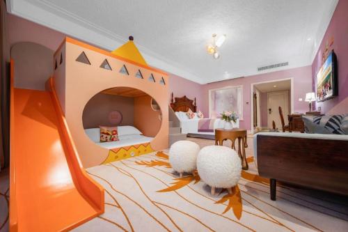a childrens bedroom with a bed with a play area at Hangzhou The First World Hotel in Hangzhou