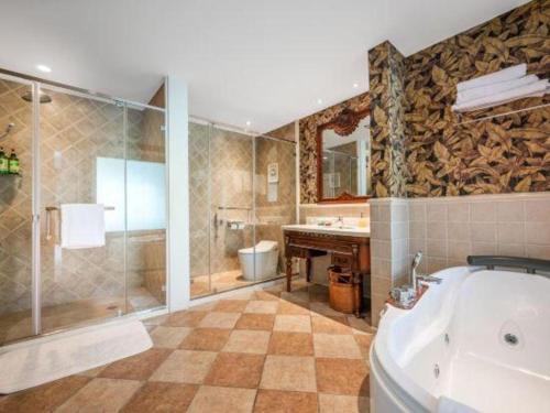 a bathroom with a tub and a shower and a sink at Hangzhou The First World Hotel in Hangzhou