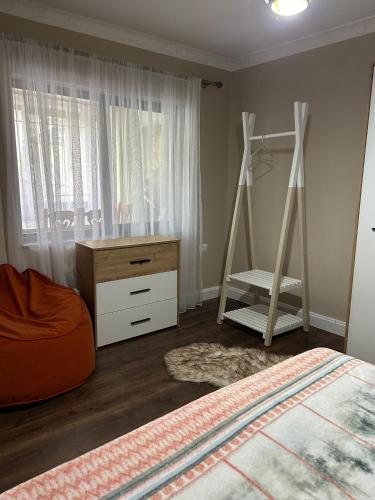 a bedroom with a bed and a desk and a ladder at Ndregjoni Albanian Village House in Klos