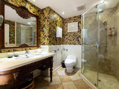 a bathroom with a toilet and a sink and a shower at Hangzhou The First World Hotel in Hangzhou