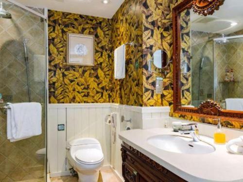 a bathroom with a toilet and a sink and a shower at Hangzhou The First World Hotel in Hangzhou