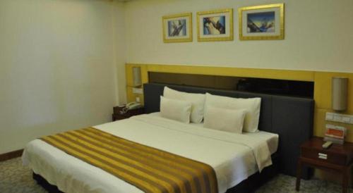 a hotel room with a large bed in a room at Xian Union Alliance Atravis Executive Hotel in Xi'an