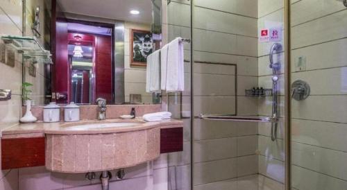 a bathroom with a sink and a shower at Changsha Huatian Hotel in Changsha