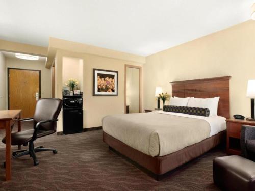 a hotel room with a bed and a desk at Quality Inn & Suites Detroit Lakes in Detroit Lakes