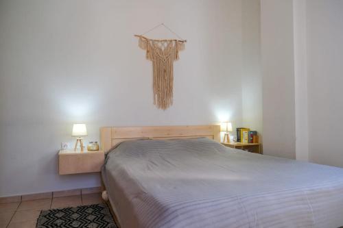 a bedroom with a bed and a lamp on the wall at Aegean Bliss - Marathos Retreat Samos in Kámpos