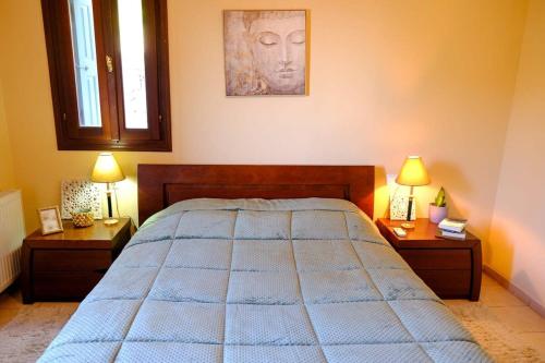 a bedroom with a large bed with two night stands at Aegean Bliss - Marathos Retreat Samos in Kámpos