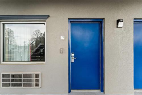 a blue door on the side of a building at Econo Lodge Fredericksburg near I-95 in Fredericksburg