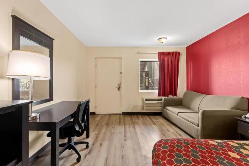 a hotel room with a bed desk and a couch at Econo Lodge Fredericksburg near I-95 in Fredericksburg