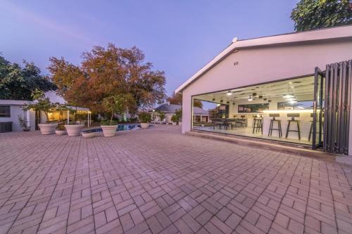 an empty parking lot with a building with windows at Room 6 - LEO Sky Guest House in Simondium