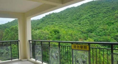 a balcony with a view of a mountain at The Century Seaview Hotel in Shenzhen