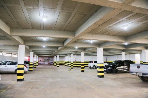 a parking garage with cars parked in it at Rota Hoteis Itumbiara in Itumbiara