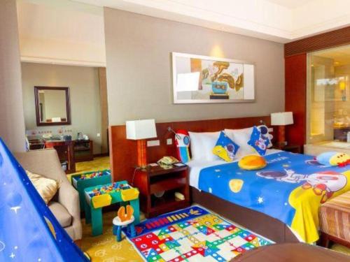 a childs bedroom with a toy bed and a couch at Quanzhou Guest House Hotel in Quanzhou
