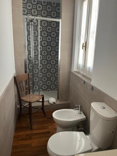 a bathroom with a toilet and a sink and a shower at La Via della Giudecca in Siracusa
