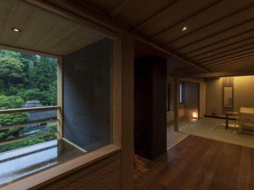 a room with a large window in a house at Myoken Ishiharaso in Kirishima