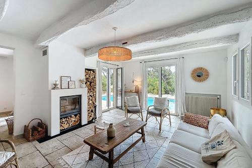 un salon avec un canapé et une cheminée dans l'établissement Mougins Charming villa with swimming pool 3 bedrooms in the pine forest, à Mougins